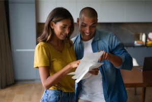 Two people looking at mail - image